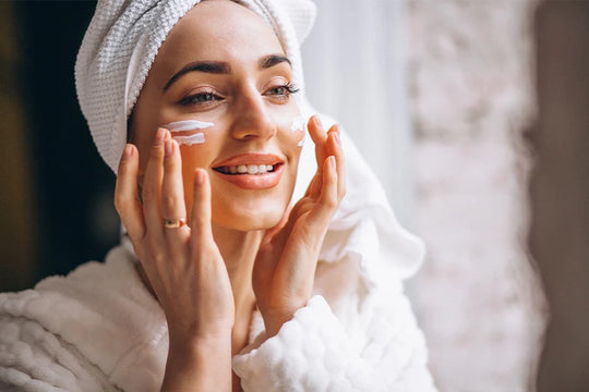 Women moisturizing her skin