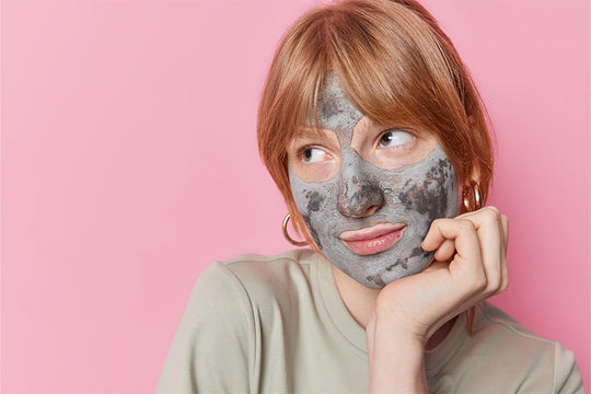 A woman in a thoughtful mood with face mask applied | face mask for dry skin 